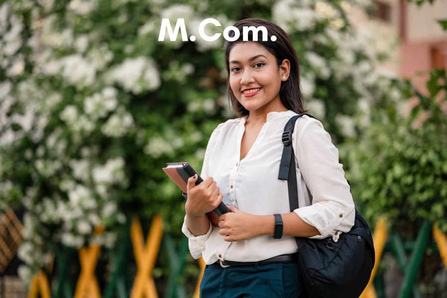 M Com